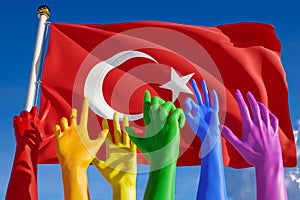 Rainbow colored hands from lgbt community over flag of Turkey. Turkish gay parade, concept of pride, freedom, elections, voting,