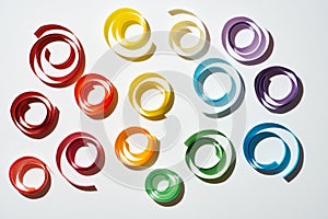 Rainbow colored paper circles on white background