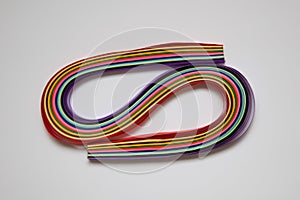 Rainbow colored quilling paper laid out in waves and shapes. Colourful Paper. A set of multi-colored paper stripes for