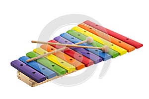Rainbow colored wooden toy xylophone against white background