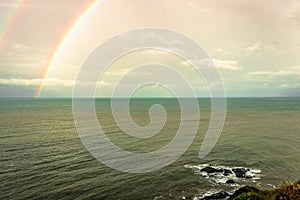 Rainbow colorful above sea horizon at dawn