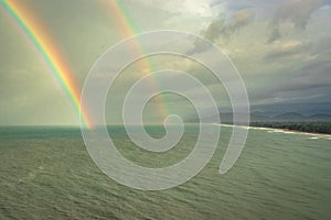 Rainbow colorful above sea horizon at dawn