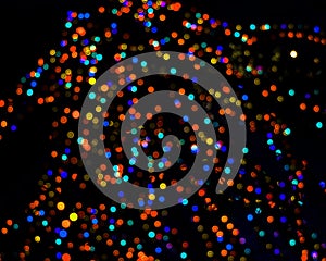 Rainbow colorful blur christmas lights background.abstract Lights unfocused blur light dots black