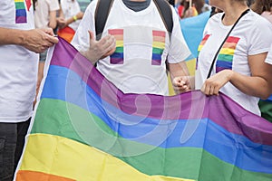 Rainbow colors cloth in hands of GayPride spectators during Pride parade. photo