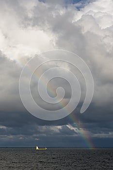 Rainbow and container ship