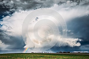 Rainbow In Countryside Rural Field Spring Meadow Landscape Under Scenic Dramatic Sky
