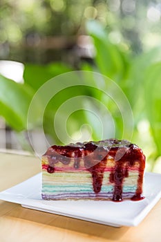 Rainbow crepe cake with blueberry syrup