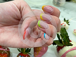 Rainbow design on long oval nails. Nail art. Multicolored French manicure