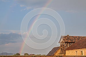 Rainbow in a field of Uljma, in the agricultural region of Banat, province of voivodina, in a field, with a barn in front