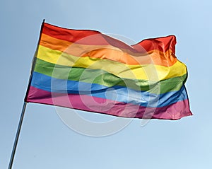 Rainbow flag on blue sky