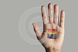 Rainbow flag in the palm of the hand