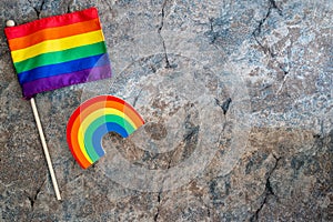 Rainbow flag and rainbow on a marble background. Concept for gay pride month, lesiban, homosexuality and gay marriage