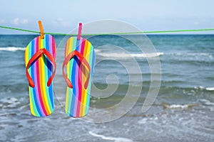 Rainbow flip-flops hanging on a clothes line