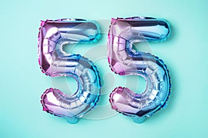 Rainbow foil balloon number, digit ninety-five. Birthday greeting card with inscription 55. Anniversary concept. Top