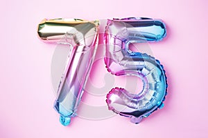 Rainbow foil balloon number, digit seventy-five. Birthday greeting card with inscription 75. Anniversary concept. Top