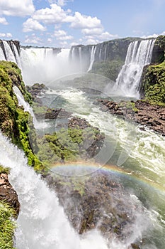 Rainbow, forest, waterfalls and river with rocks