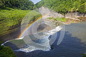 A rainbow at the top of a waterfall