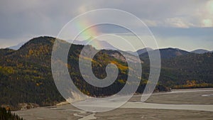 Rainbow forms Wrangell Mountains rainstorm river basin Alaska