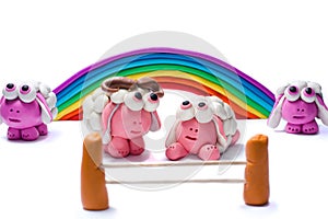 Rainbow and four plasticine sheep.