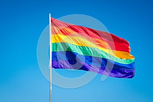 Rainbow Gay Pride Flag on blue sky backgrond, Miami Beach, Fllorida, USA
