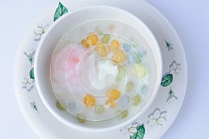 rainbow glutinous rice balls with sweet eeg on white background.Thai traditional dessert