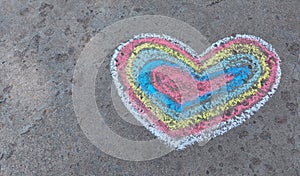 Rainbow heart drawn with chalk on the asphalt. love confession. banner place for text, valentine, children creativity copy space,