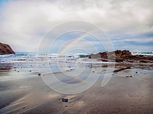 Rainbow at the Itzurun Beach in Zumaia, Basque Country, Spain