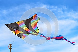 Rainbow kites are floating in the sky. which are generally sold along the beach in Pattaya