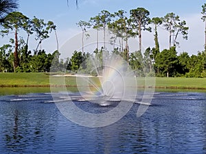Rainbow in lake fountain on a golf course