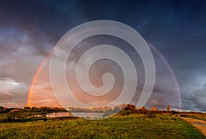 Rainbow landscape and dramatic rain sky