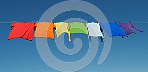 Rainbow laundry, bright shirts on a clothesline