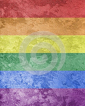 Rainbow LGBTQ or gay pride flag on decorative plaster or concrete texture. Abstract background