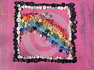 Rainbow made of sewing buttons background - stock photo