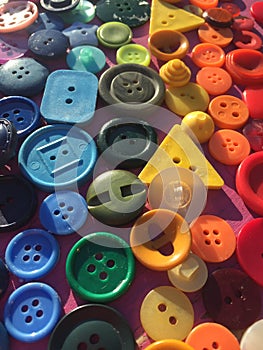 Rainbow made of sewing buttons background - stock photo