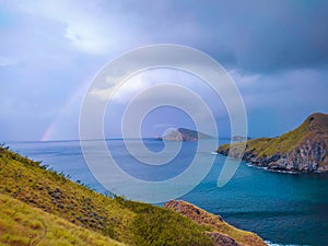 a rainbow in the middle of a sea that is so beautiful, the sea is the most comfortable place to unwind