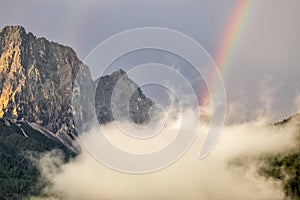 Rainbow between mountains after rain