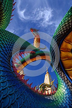 Rainbow Naga and Wat Phra That Nong Bua on a bright day.