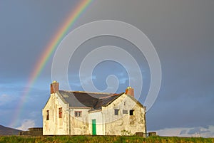 Rainbow over abandoned house