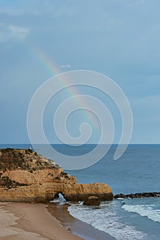 Rainbow over the Atlantic Ocean. Praia dos Tres Castelos in Algarve, Portugal