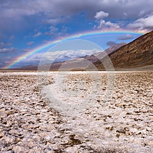 Rainbow over Badwater in Death Valley photo