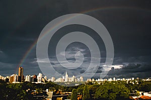 Rainbow over buldings and catheral during sunset in Maringa, Parana, Brazil