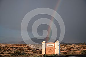 Rainbow over dunes and a dune road. Corralejo National Park, morning, Las Palmas Province, Fuerteventura, Canary Islands, Spain