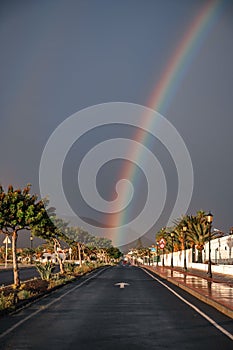 Rainbow over dunes and a dune road. Corralejo National Park, morning, Las Palmas Province, Fuerteventura, Canary Islands, Spain