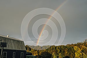 Rainbow over forest, a top of cabin