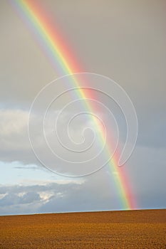 Rainbow over freshly ploughed land.