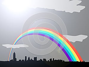 Rainbow over grey cloudy city skyline