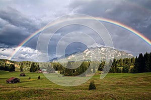 Rainbow over Karwendel Alps and meadows