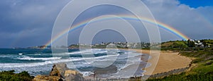 Rainbow over Kiama, NSW, Australia, view across Bombo beach