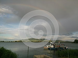 Rainbow over the lake and hills in South Moravia