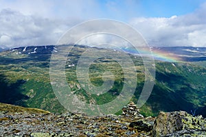 The rainbow over mountains during sunsetin the WIlderness of Norway two photo